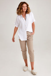 Model Emma wearing size S of the Santorini Cotton Pant in colour Natural, from the front, showing the whole outfit