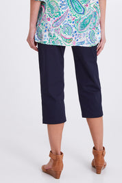 Model Madeline wearing size S of the Santorini Cotton Pant in colour Navy (Blue), from the back