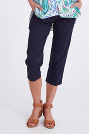 Model Madeline wearing size S of the Santorini Cotton Pant in colour Navy (Blue), from the front, cropped image
