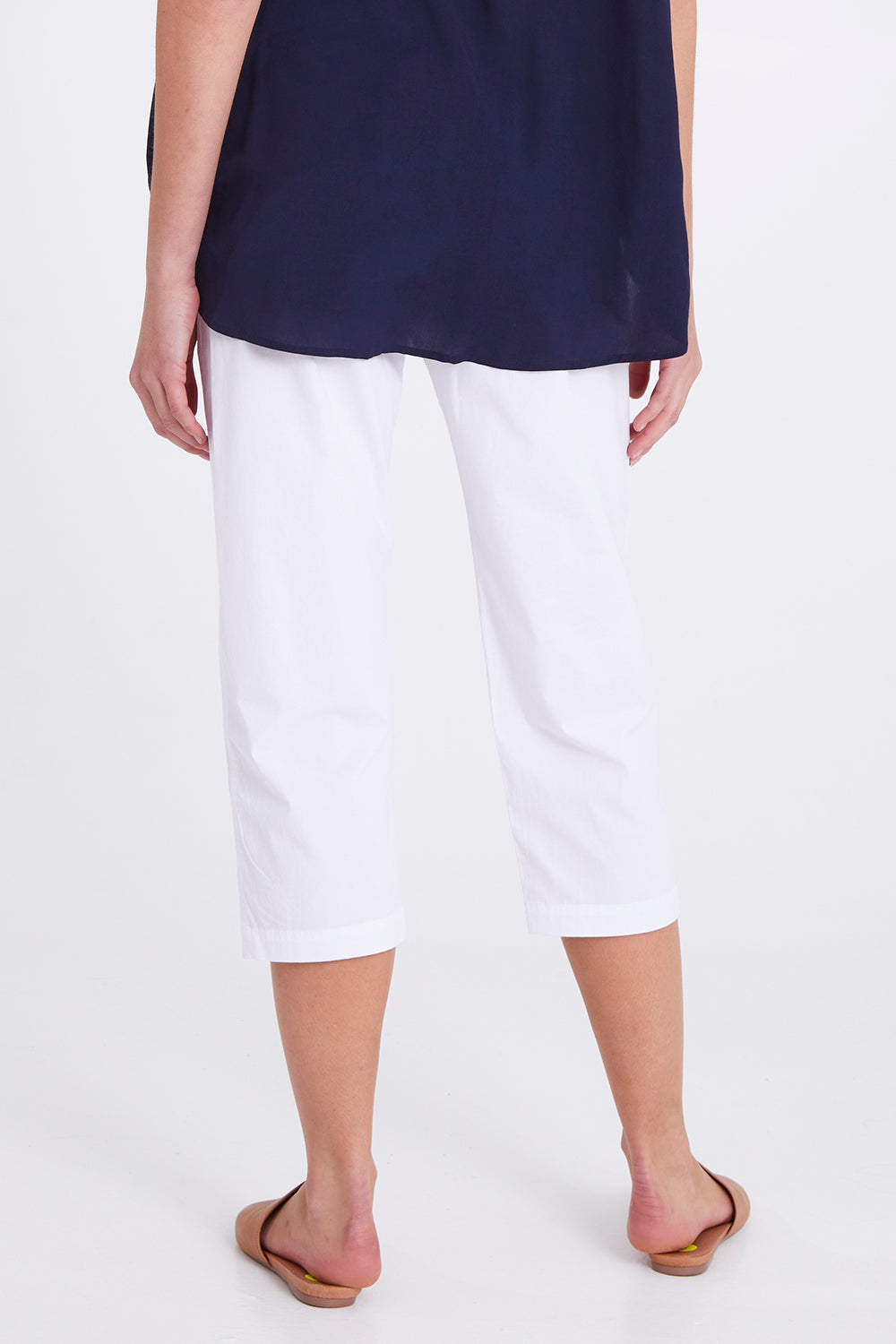 Model Madeline wearing size S of the Santorini Cotton Pant in colour White (White), from the back