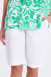 Model Madeline wearing size S of the Santorini Cotton Short in colour White (White), from the front, cropped image