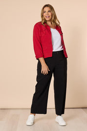 A model wearing the Maggie Denim Jacket in colour Red (Red), from the front, showing the whole outfit