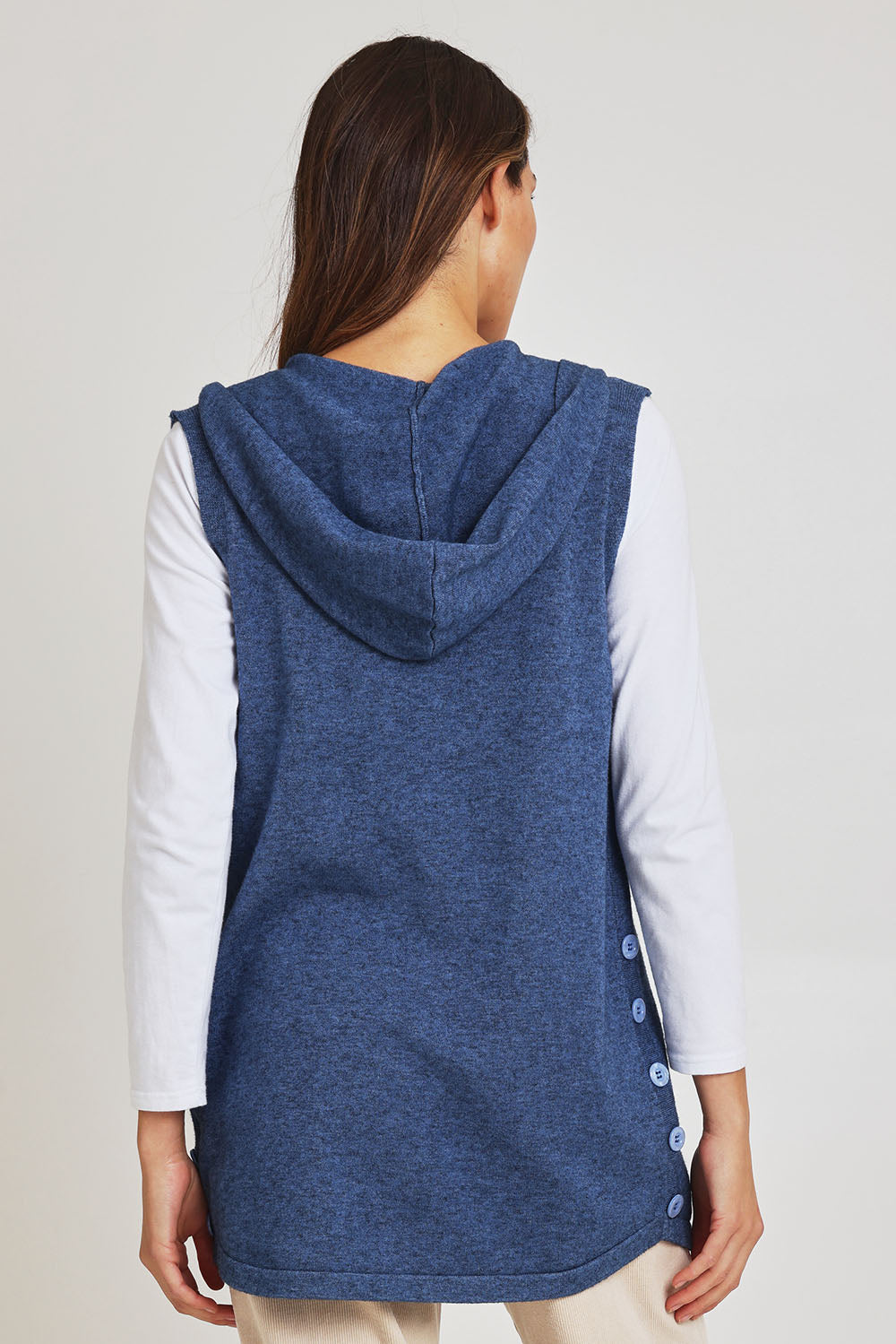 Model Madeline wearing size S of the Ollie Side Button Knit Vest in colour Indigo (Blue), from the back