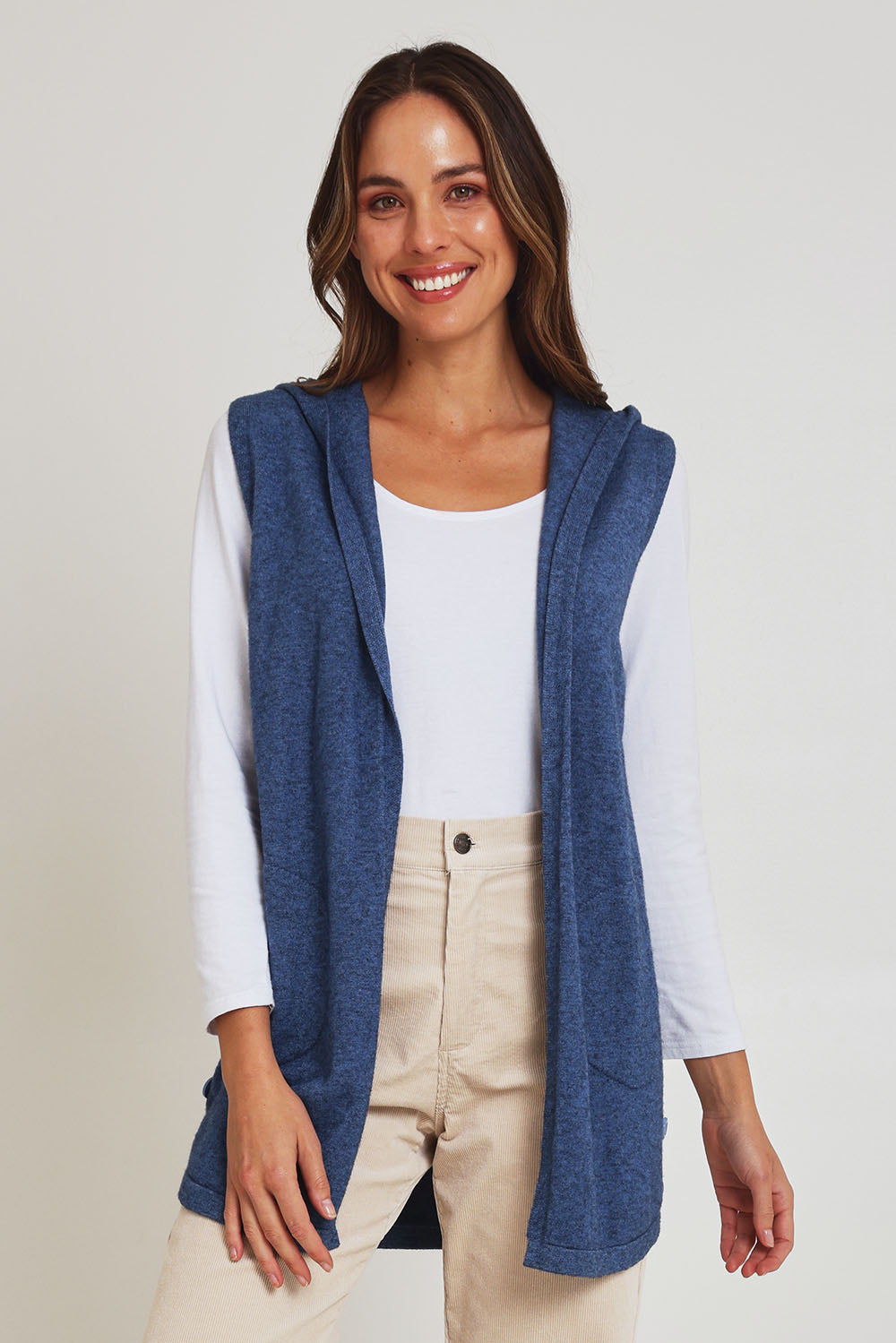 Model Madeline wearing size S of the Ollie Side Button Knit Vest in colour Indigo (Blue), from the front, cropped image