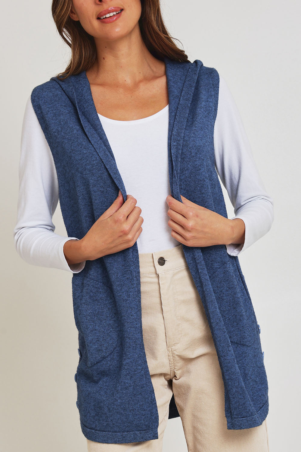 Model Madeline wearing size S of the Ollie Side Button Knit Vest in colour Indigo (Blue), from the front, cropped image