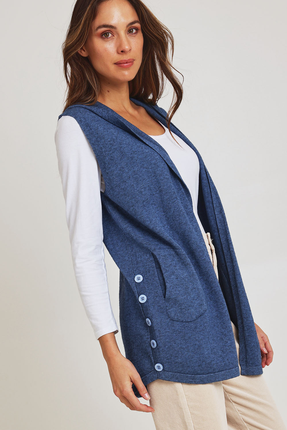 Model Madeline wearing size S of the Ollie Side Button Knit Vest in colour Indigo (Blue), from the front, cropped image