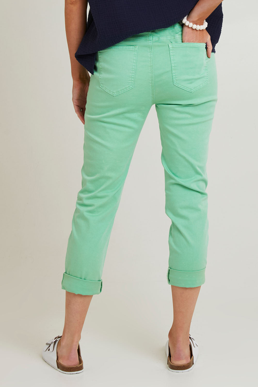 Model Grace wearing size S of the Isabella Cotton Pant in colour Green (Green), from the back