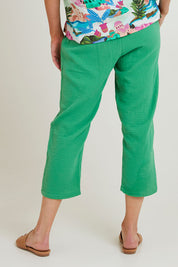Model Grace wearing size S of the Byron Cotton 7/8 Pant in colour Emerald (Green), from the back