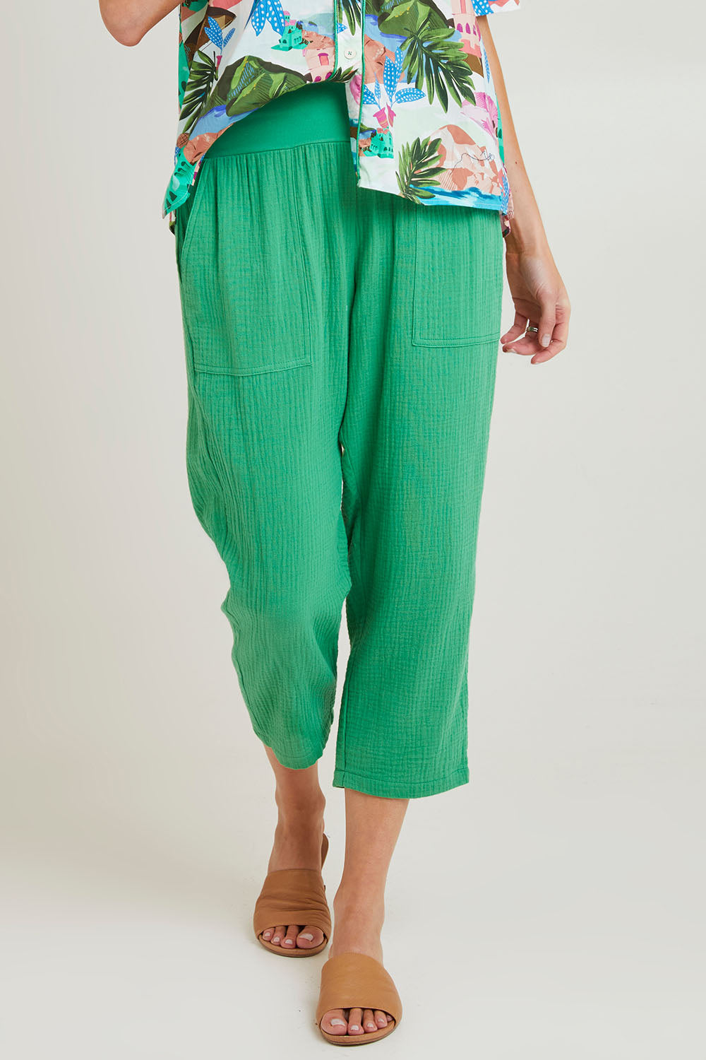 Model Grace wearing size S of the Byron Cotton 7/8 Pant in colour Emerald (Green), from the front, cropped image