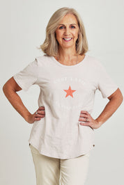 Model Sandy wearing size S of the C'est La Vie Cotton Tee in colour Natural, from the front, cropped image