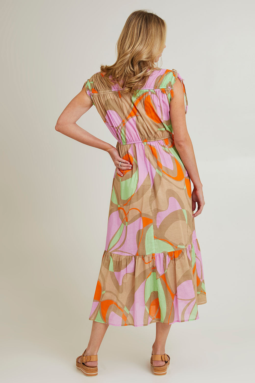 Model Grace wearing size S of the Grazia Mio Cotton Dress in colour Stone, from the back
