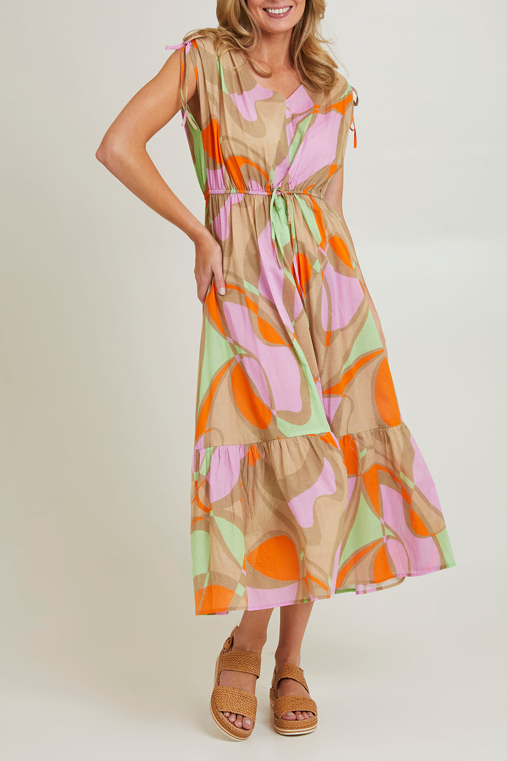 Model Grace wearing size S of the Grazia Mio Cotton Dress in colour Stone, from the front, cropped image