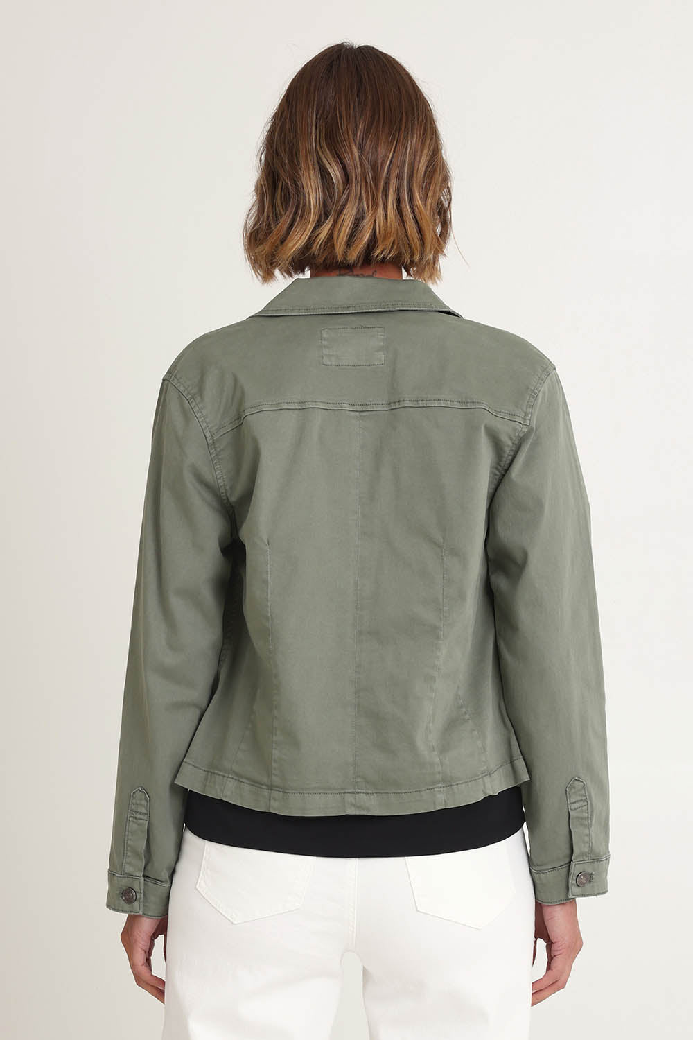 Model Riina wearing size S of the Retro Denim Jacket in colour Washkhaki (Green), from the back