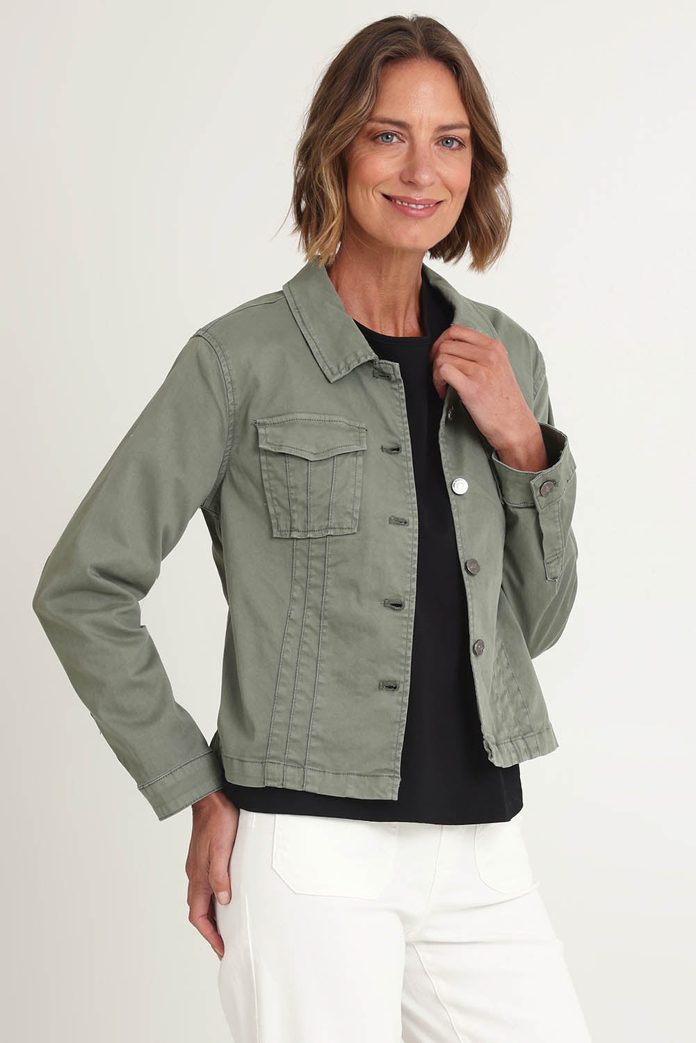 Model Riina wearing size S of the Retro Denim Jacket in colour Washkhaki (Green), from the front, cropped image