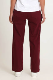 Model Riina wearing size S of the Carpenter Wide Leg Jean in colour Shiraz (Red), from the back
