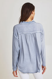 Model Madeline wearing size S of the Paige Garment Washed Shirt in colour Washblue (Blue), from the back