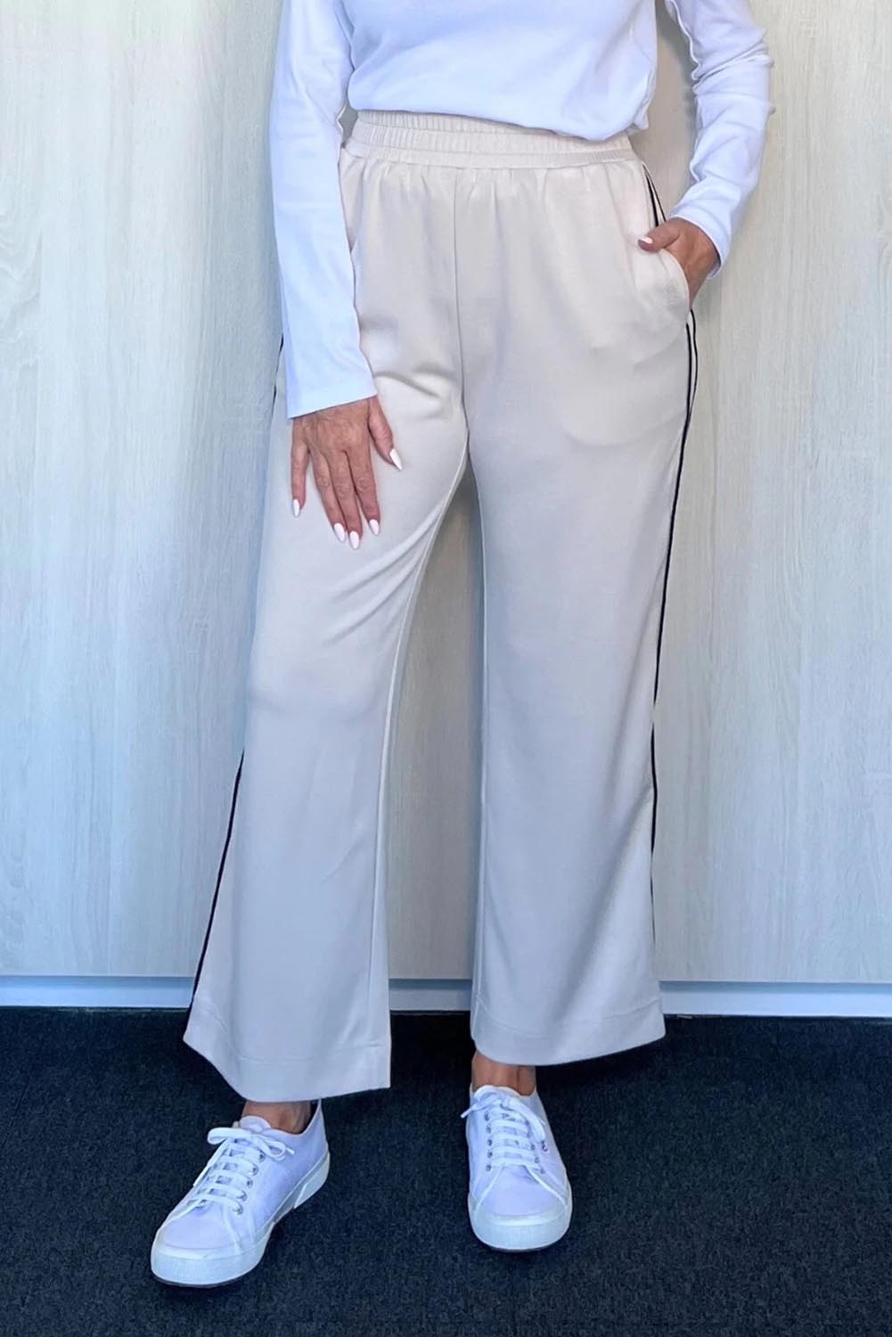 A model wearing the Urban Crop Pant in colour Chalk, from the front, cropped image