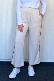 A model wearing the Urban Crop Pant in colour Chalk, from the front, cropped image