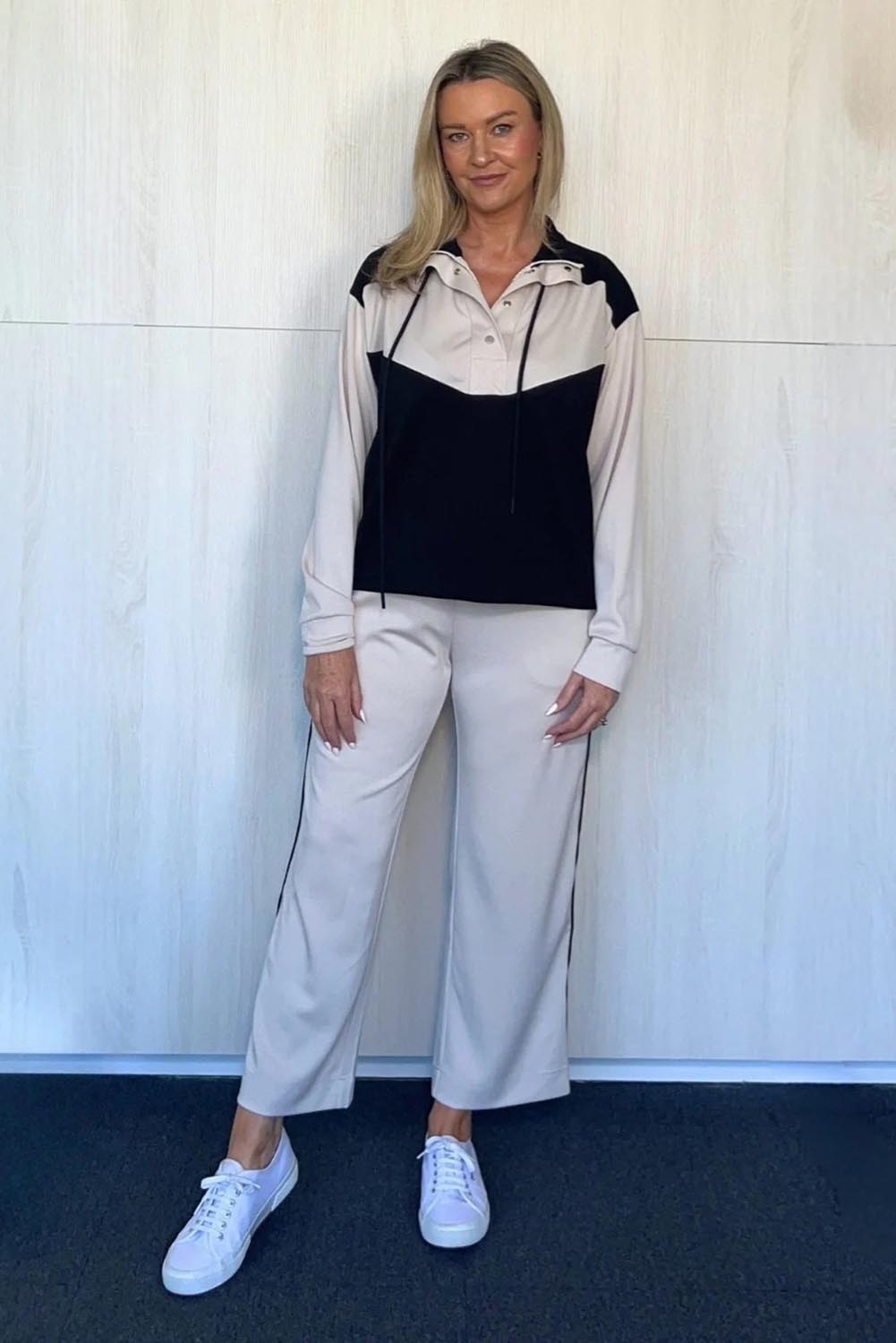 A model wearing the Urban Crop Pant in colour Chalk, from the front, showing the whole outfit