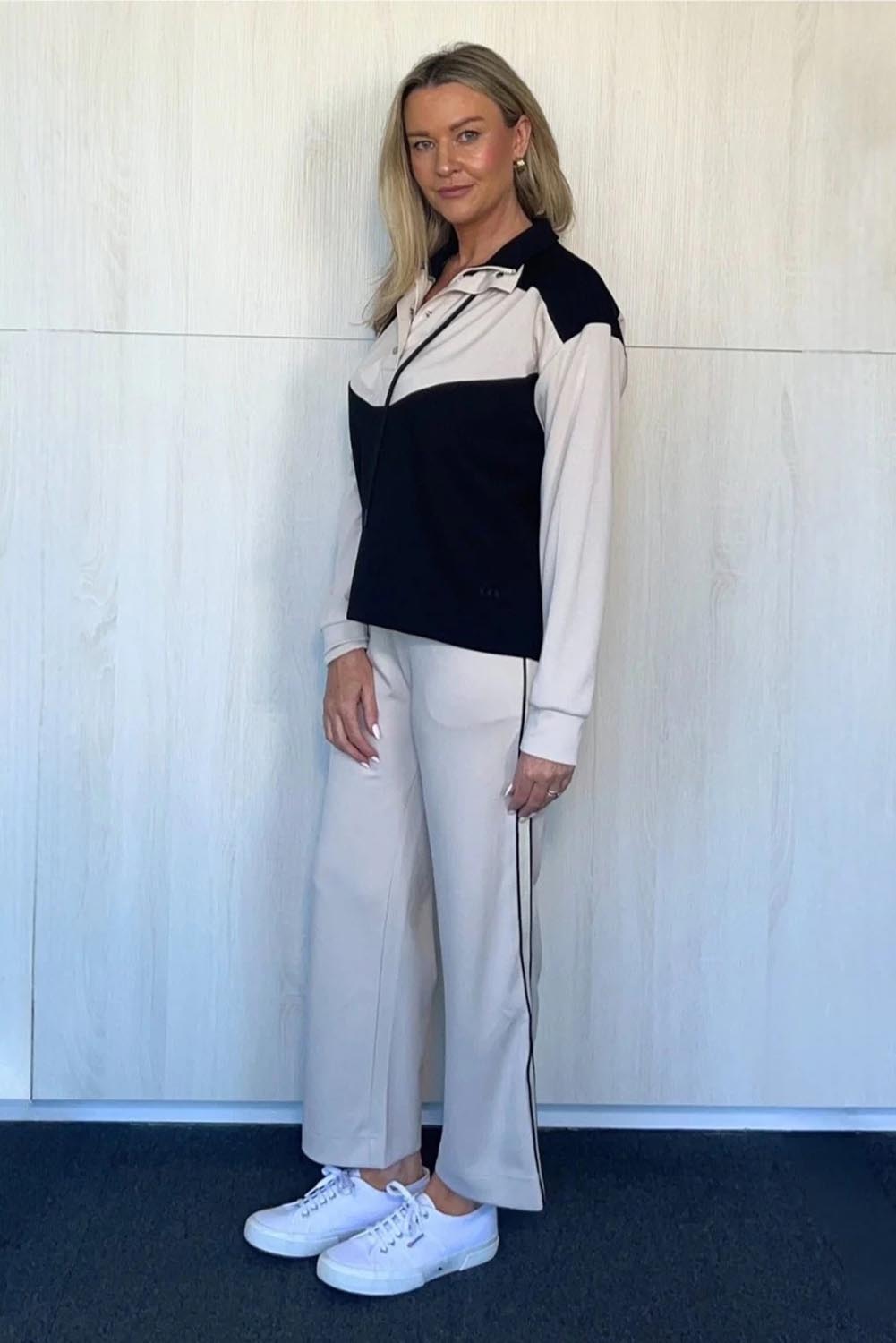 A model wearing the Urban Crop Pant in colour Chalk, from the front, showing the whole outfit
