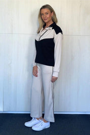 A model wearing the Urban Crop Pant in colour Chalk, from the front, showing the whole outfit