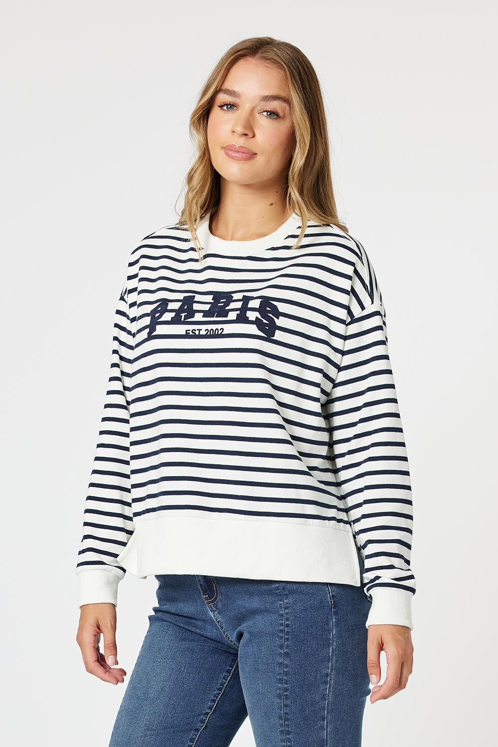 A model wearing the Paris Stripe Sweatshirt in colour Navy (Blue), from the front, cropped image