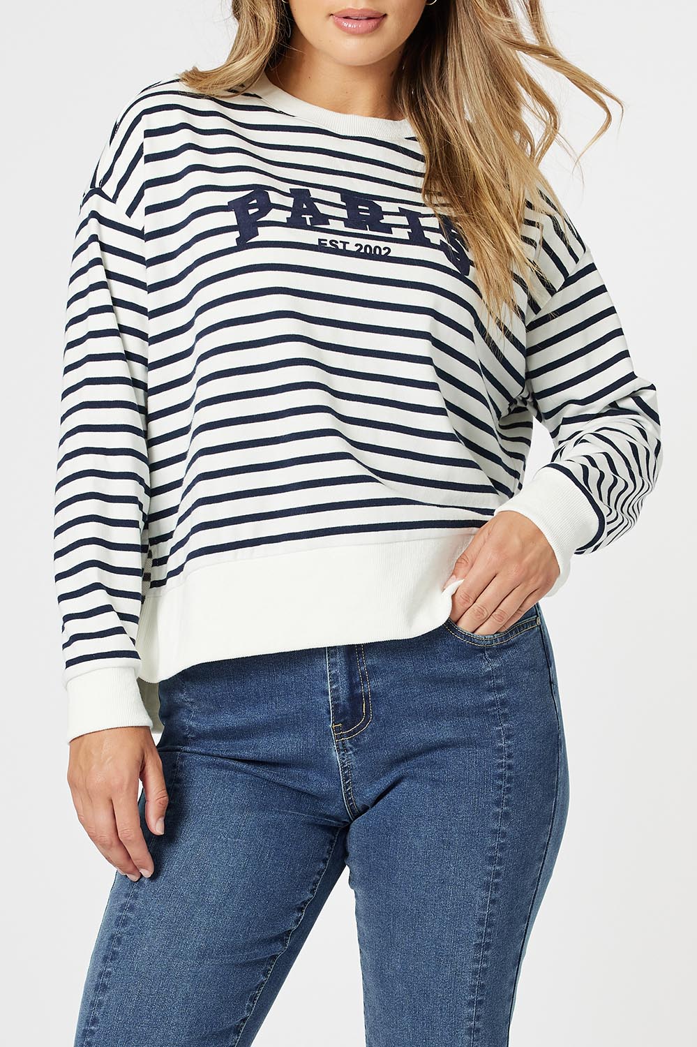 A model wearing the Paris Stripe Sweatshirt in colour Navy (Blue), from the front, cropped image