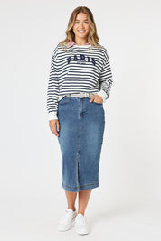 A model wearing the Paris Stripe Sweatshirt in colour Navy (Blue), from the front, showing the whole outfit