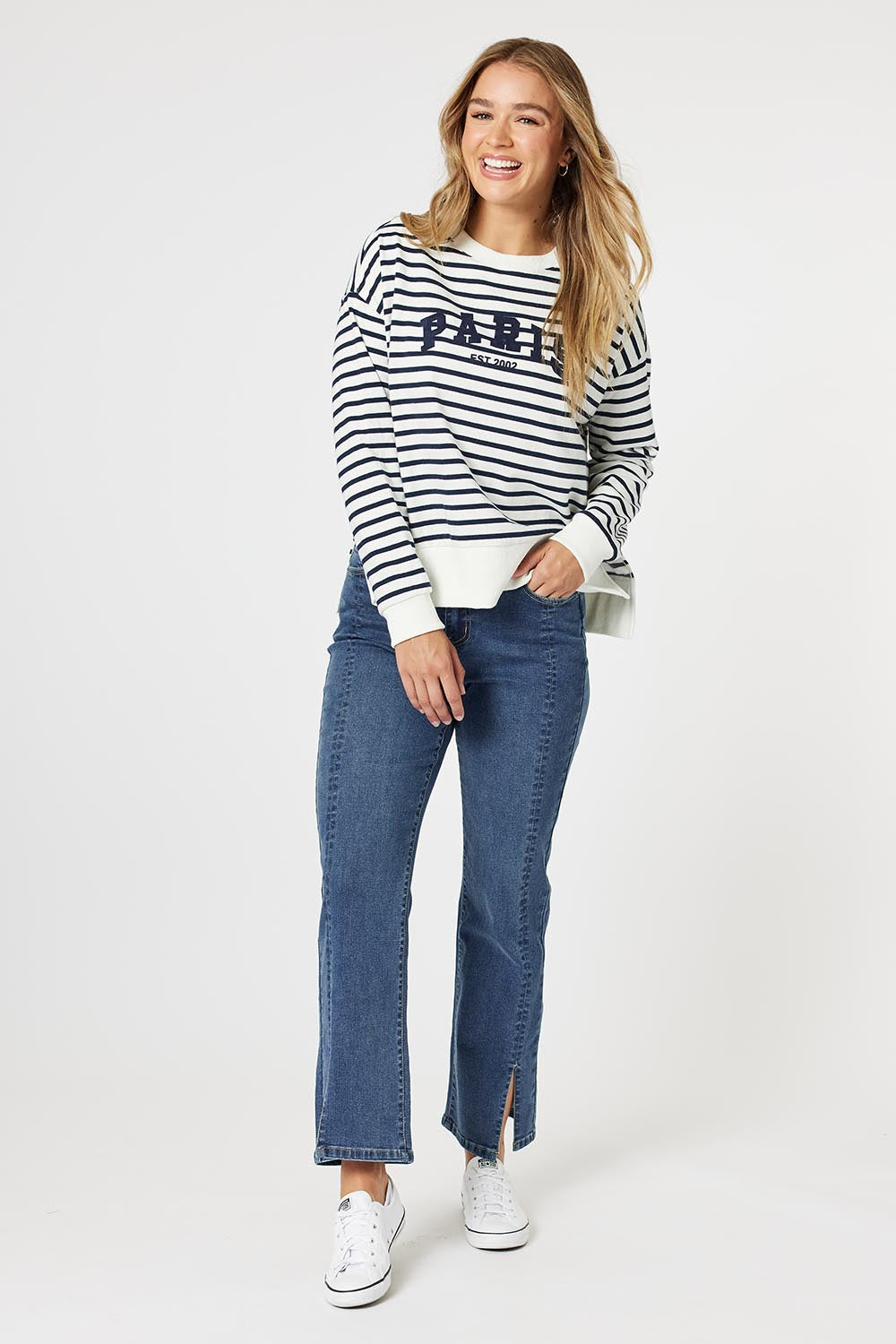 A model wearing the Paris Stripe Sweatshirt in colour Navy (Blue), from the front, showing the whole outfit