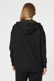 A model wearing the Evie Sweatshirt in colour Black (Black), from the back