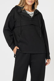 A model wearing the Evie Sweatshirt in colour Black (Black), from the front, cropped image