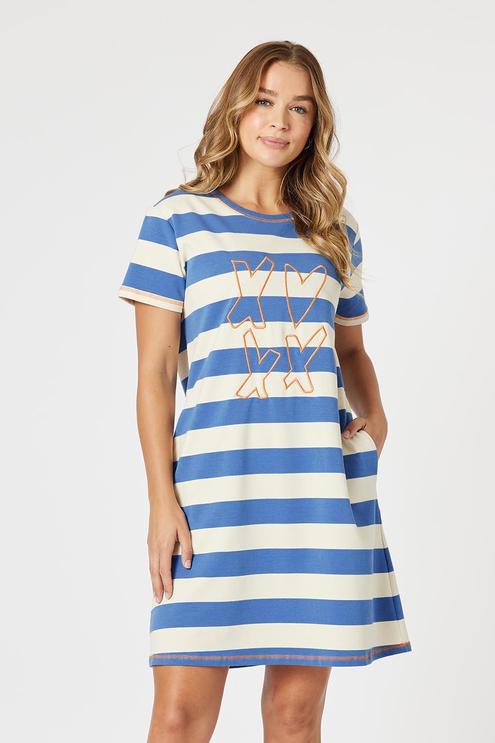 A model wearing the Love & Kisses Cotton Dress in colour Blue (Blue), from the front, cropped image