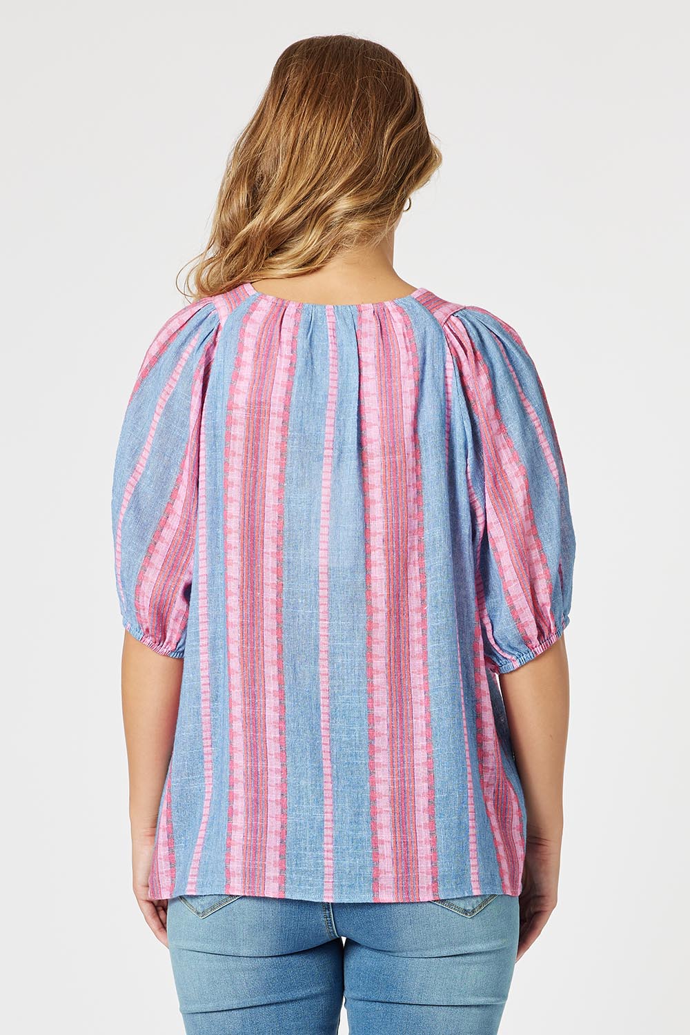 A model wearing the Bloom Stripe Cotton Top in colour Indigopink, from the back