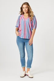 A model wearing the Bloom Stripe Cotton Top in colour Indigopink, from the front, showing the whole outfit