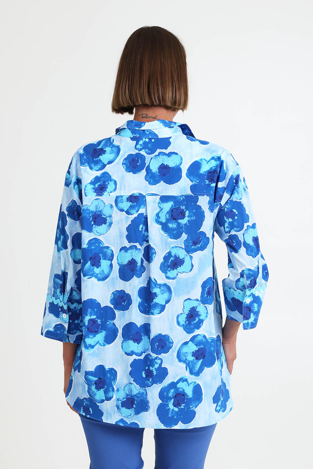 Model Riinar wearing size 10 of the Poppies Shirt – Aqua in colour Aqua, from the back