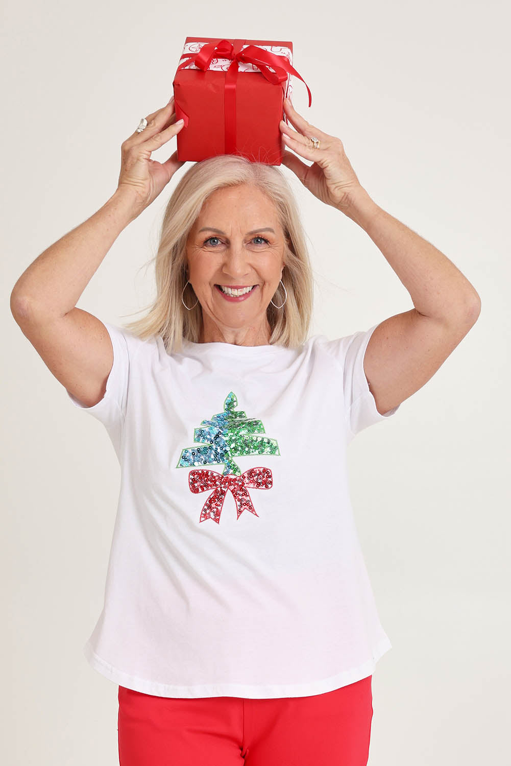 Model Sandy wearing size S of the Sequin Christmas Tree Cotton Tee in colour White (White), from the front, cropped image