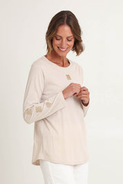 Model Riina wearing size S of the Heart Square Tee in colour Natural, from the front, cropped image