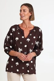 Model Riinar wearing size 10 of the Canopy Embroidered Top – Coffee in colour Coffee, from an angle
