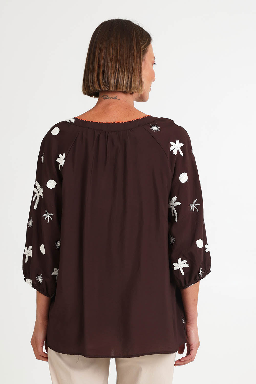Model Riinar wearing size 10 of the Canopy Embroidered Top – Coffee in colour Coffee, from the back