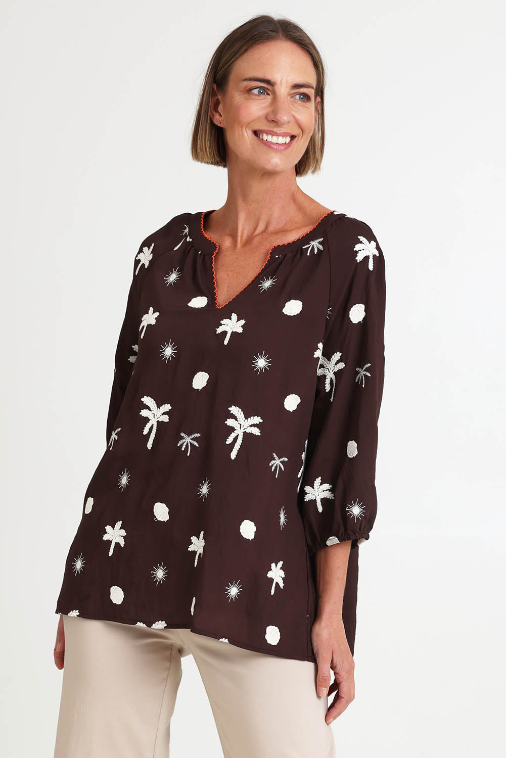 Model Riinar wearing size 10 of the Canopy Embroidered Top – Coffee in colour Coffee, in a cropped view