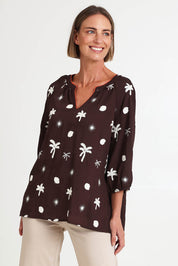 Model Riinar wearing size 10 of the Canopy Embroidered Top – Coffee in colour Coffee, in a cropped view