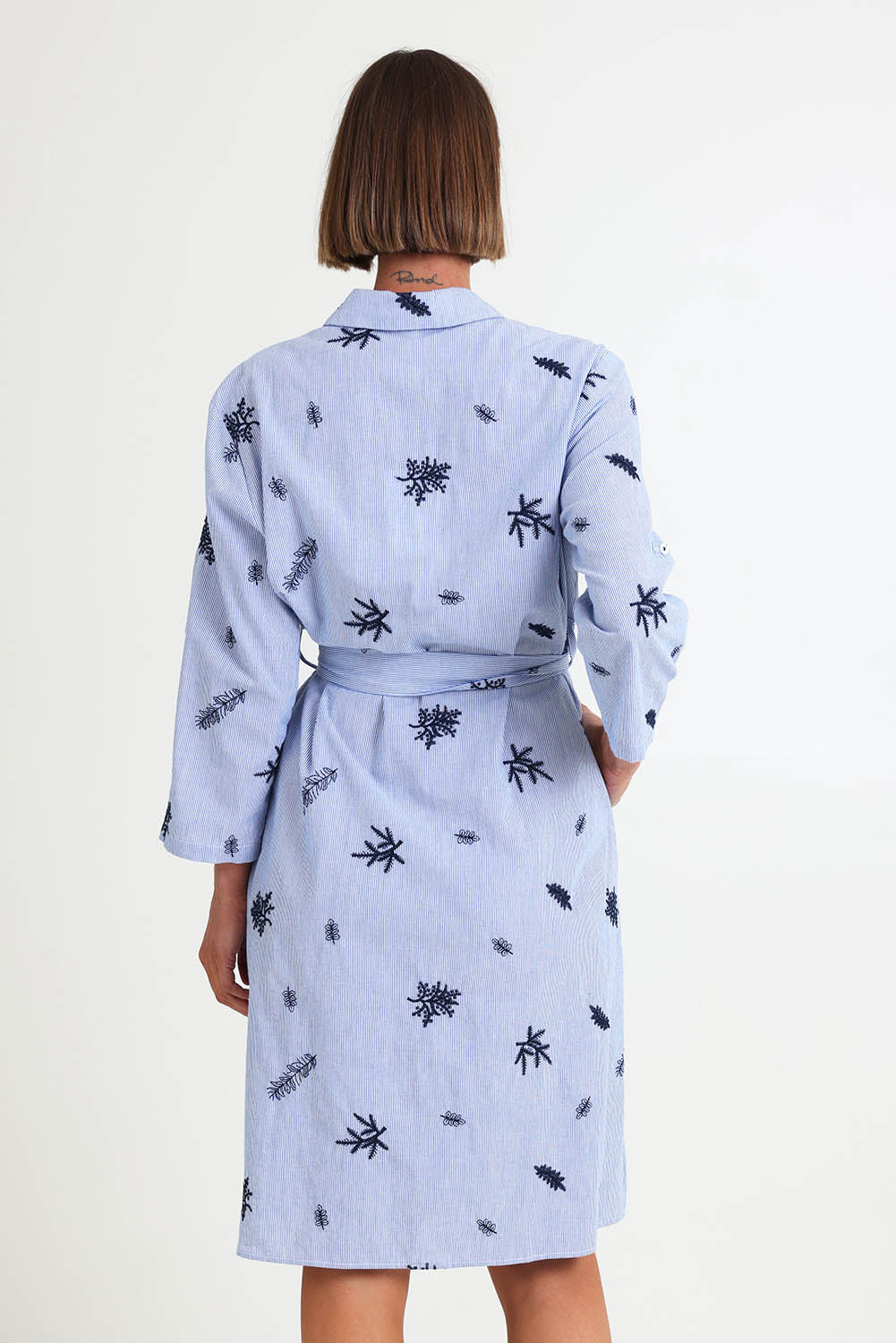 Model Riinar wearing size 10 of the Botanica Shirt Dress – Navy in colour Navy, from the back