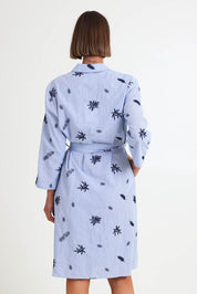 Model Riinar wearing size 10 of the Botanica Shirt Dress – Navy in colour Navy, from the back