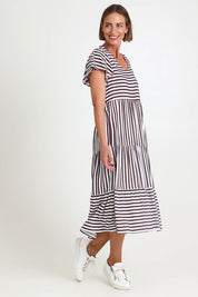 Model Riinar wearing size 10 of the Kalahari Stripe Dress – Coffee in colour Coffee, from the front