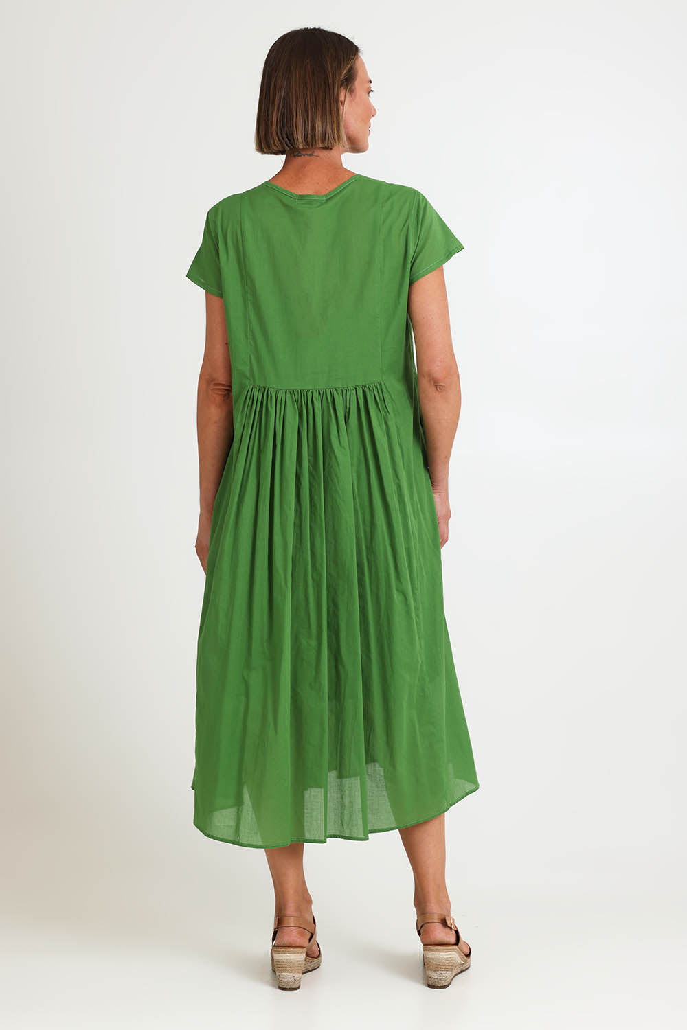 Model Riinar wearing size 10 of the Acacia Cotton Dress – Apple in colour Apple, from the front