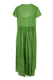 Product shot of the Acacia Cotton Dress – Apple in colour Apple, from the back