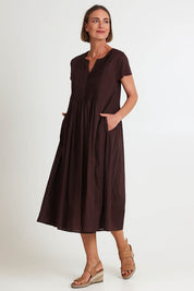 Model Riinar wearing size 10 of the Acacia Cotton Dress – Coffee in colour Coffee, from the front