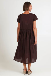 Model Riinar wearing size 10 of the Acacia Cotton Dress – Coffee in colour Coffee, from the front