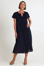 Model Riinar wearing size 10 of the Acacia Cotton Dress – Navy in colour Navy, from the front