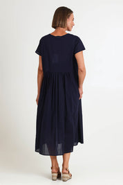 Model Riinar wearing size 10 of the Acacia Cotton Dress – Navy in colour Navy, from the front